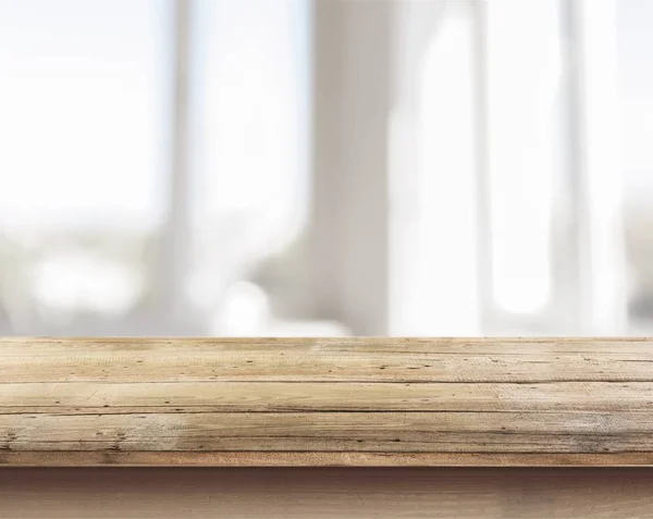 Empty wooden surface on blurred background