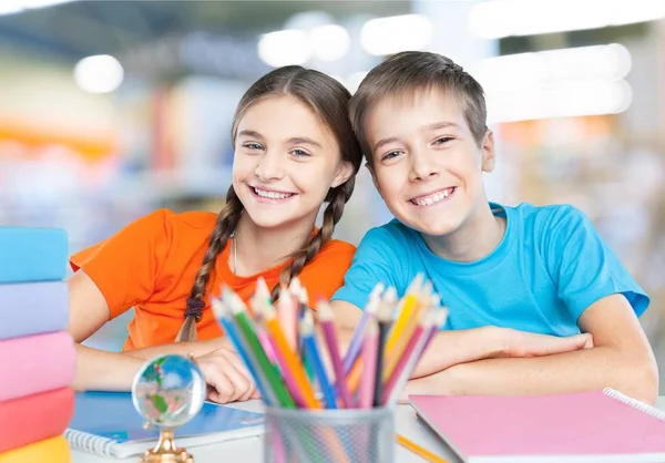 Children sitting by the table during lesson — Stock Photo, Image