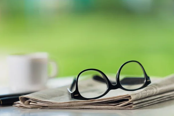 Stack of newspapers and eyeglasses — Stock Photo, Image