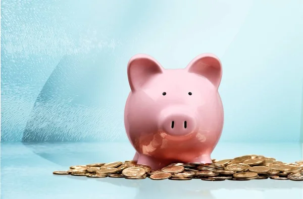 Piggy bank and coins on light background