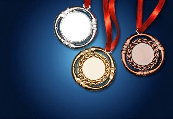 Gold, silver and bronze medals on blue background