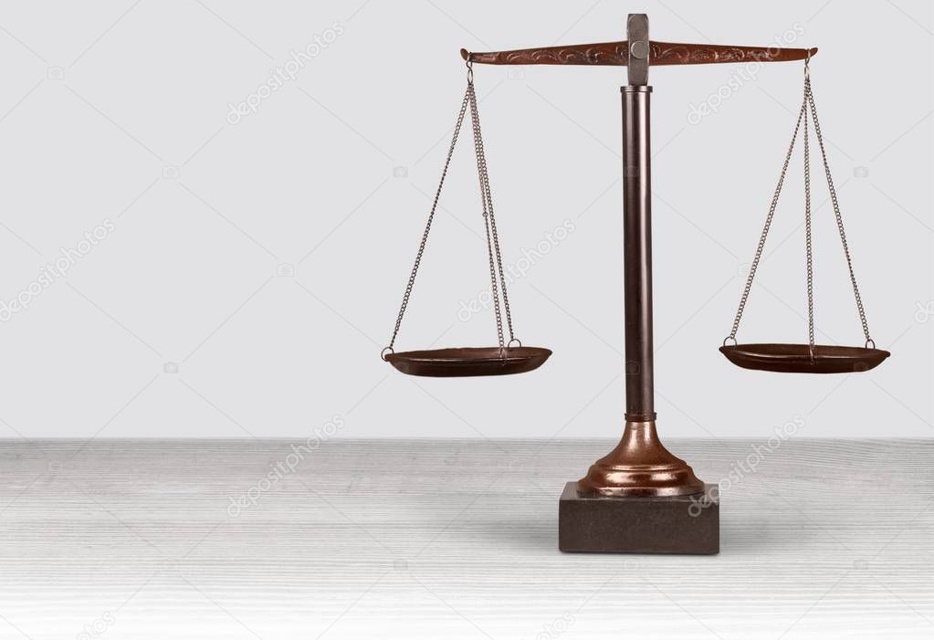 Law scales on table on  background 