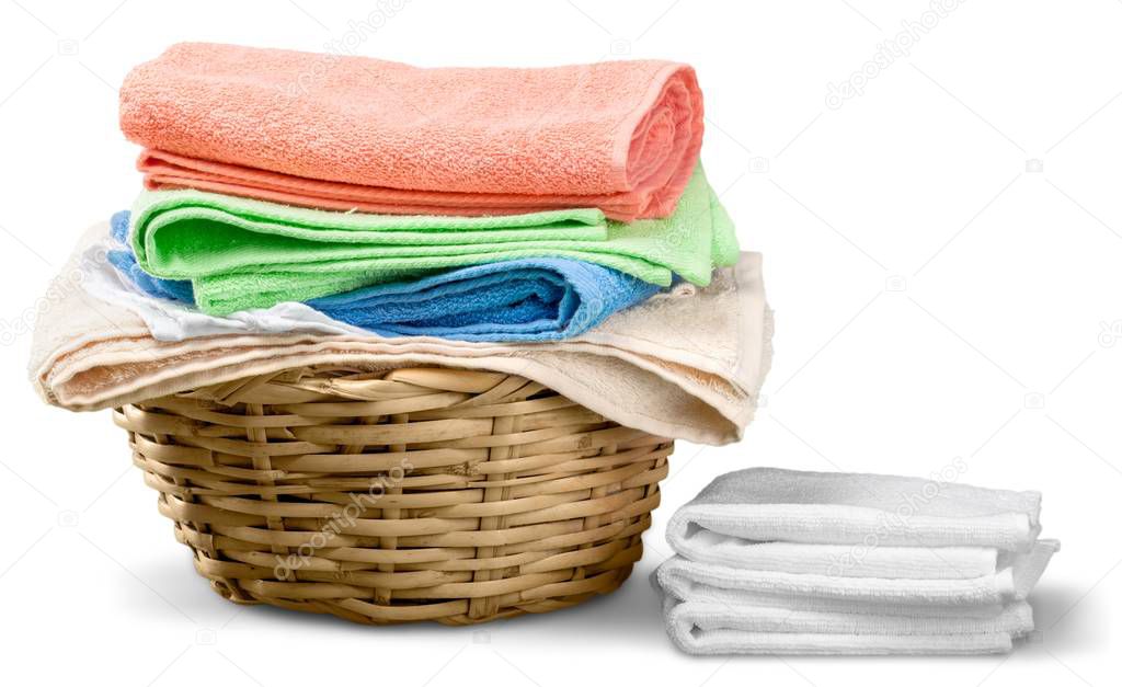 Pile of fluffy towels  and wicker basket 
