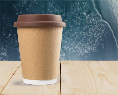 Coffee in paper cup with plastic lid clipart