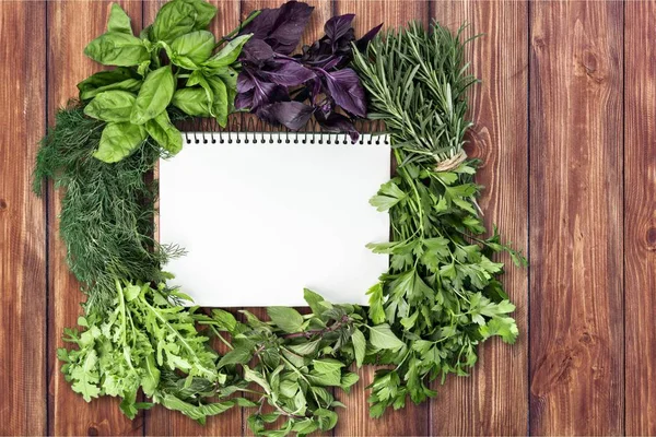 Green fresh herbs mix around the frame , top view