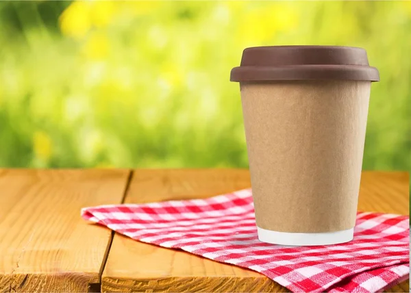 Coffee in paper cup with plastic lid