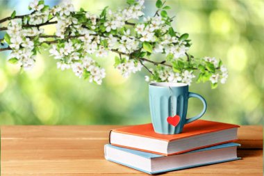 Yığın tabloda çay bardağı ile kitap