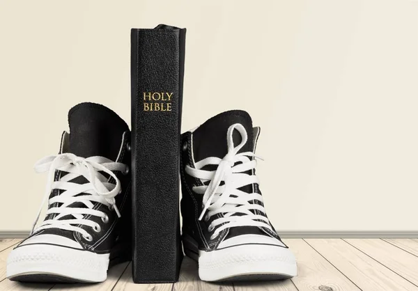 Holy bible book and black gumshoes