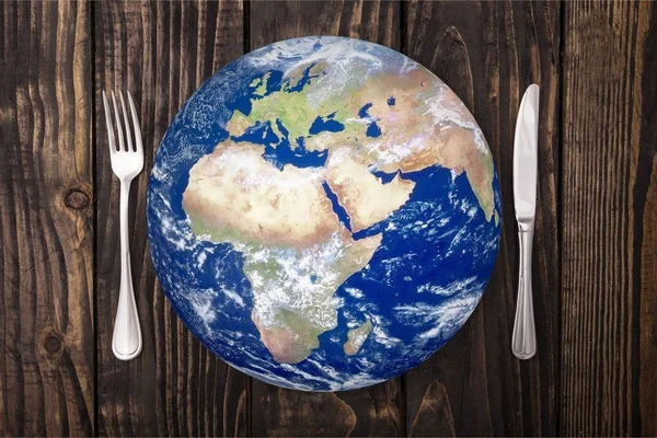 Earth globe with fork and knife