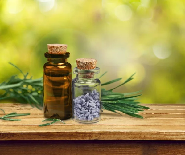 Herbal oil in bottle on wooden table