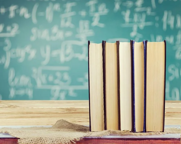 Stack of vintage books on  background