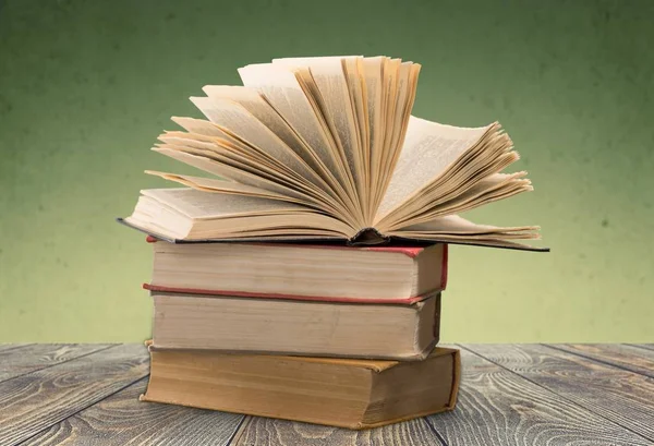 Stack of vintage books on  background