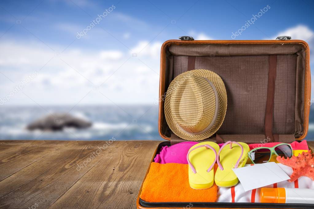 Retro suitcase with flip flops and clothes. Travel and vacation