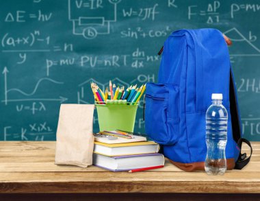 Ahşap masa üzerinde okul sırt çantası ile ileti örneği