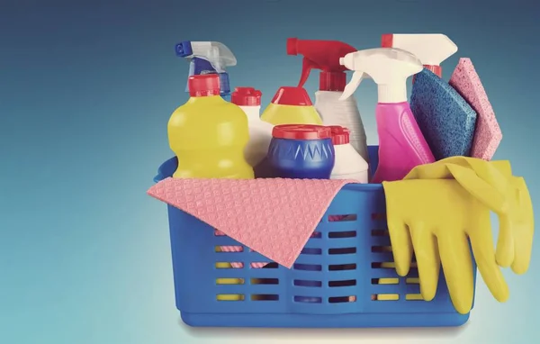 Cleaning supplies in basket isolated on background