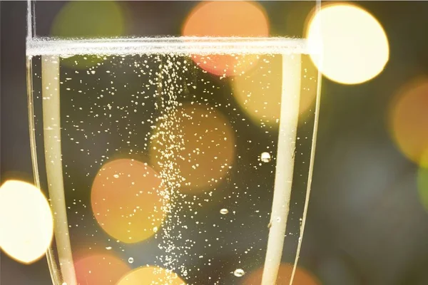 Flute glass of champagne on bright background