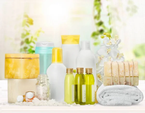 spa treatment concept. White towel, bottles with cosmetics, towel and soap