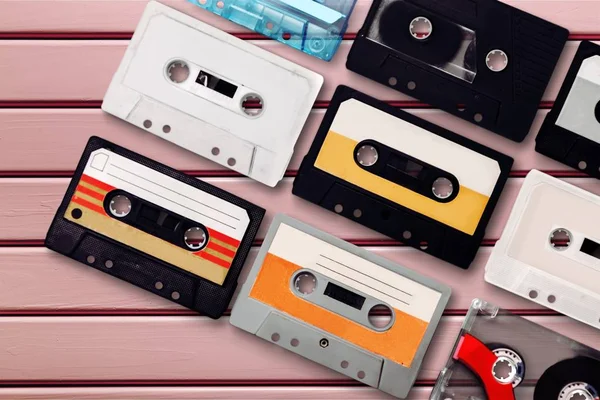 Collection of retro audio tapes on background