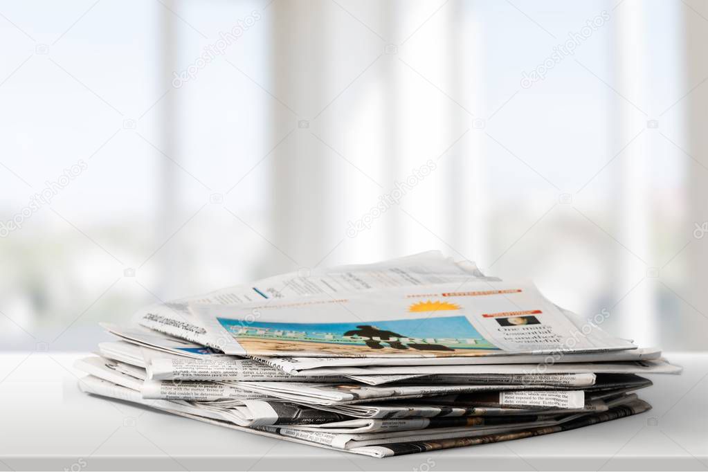 Pile of newspapers on background, close-up view