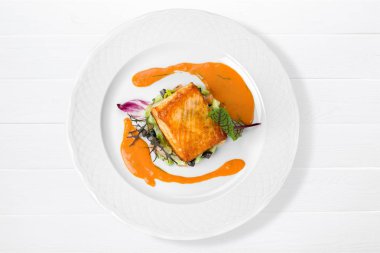 Beyaz tabakta sebzeli ızgara somon balık