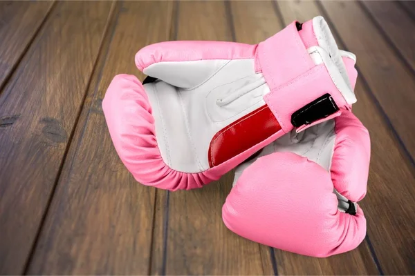 Pink boxing gloves on background