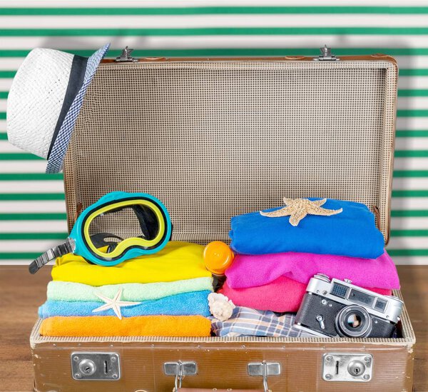 Retro suitcase with clothes and snorkeling mask. Travel and vacation