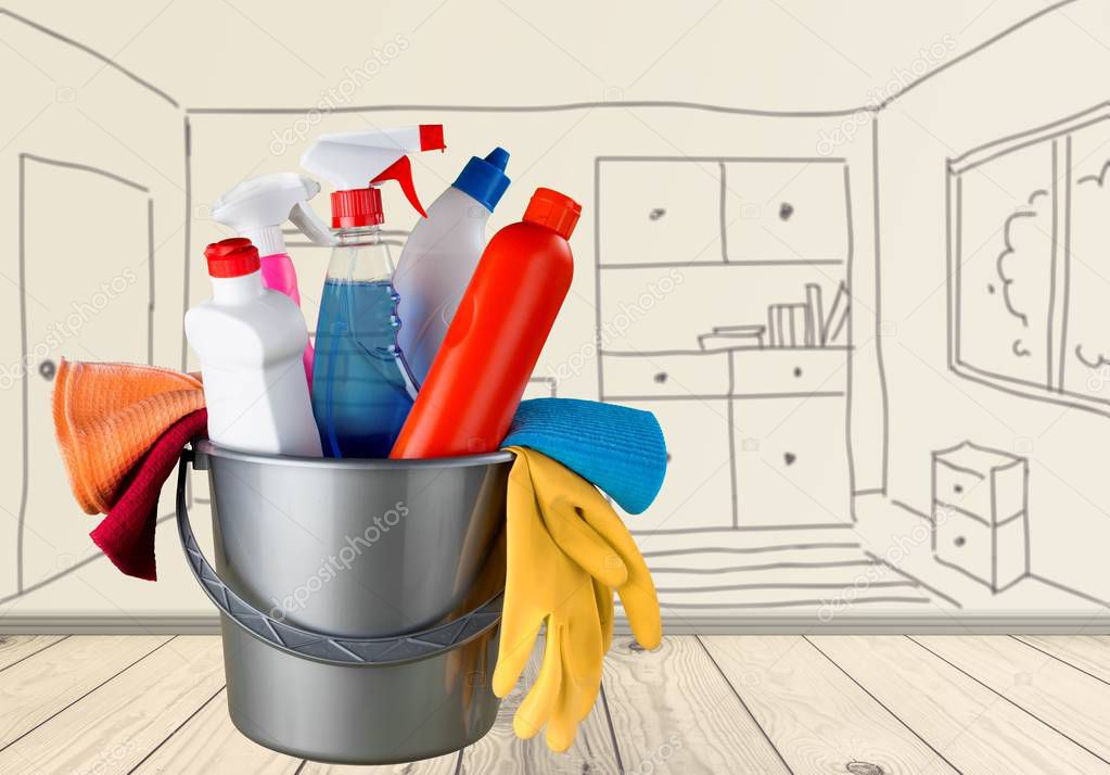 Cleaning supplies in blue bucket at home