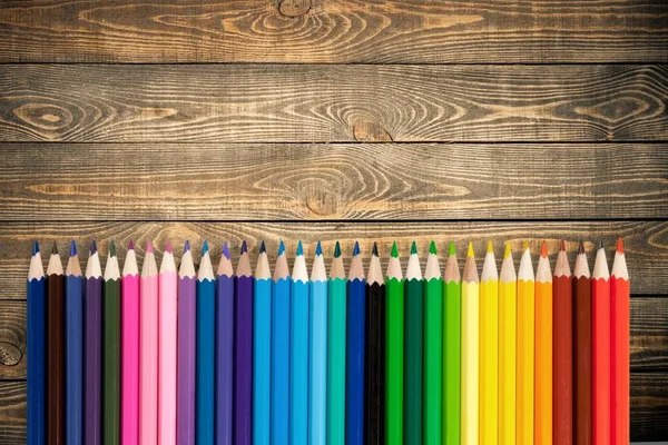 Colorful pencils on table background