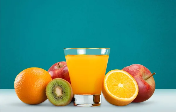 tasty orange juice in glass and fresh fruits