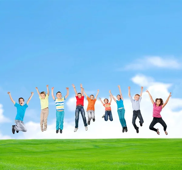 Happy Kids Jumping Grassy Lawn Sunny Day — Stock Photo, Image