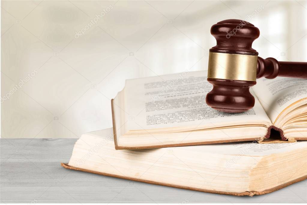 Wooden judge gavel with books, law and justice concept