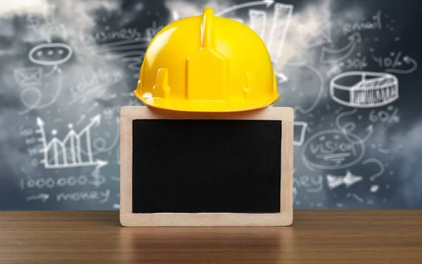 Work Place Safety Concept with safety equipment and a blackboard