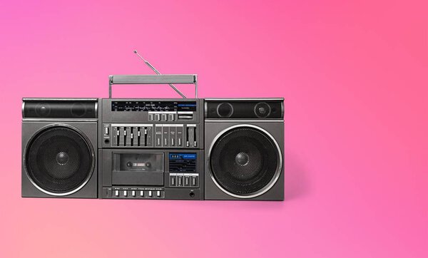 Old boombox on a pink background