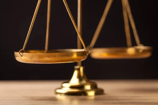 Law scales on table on background