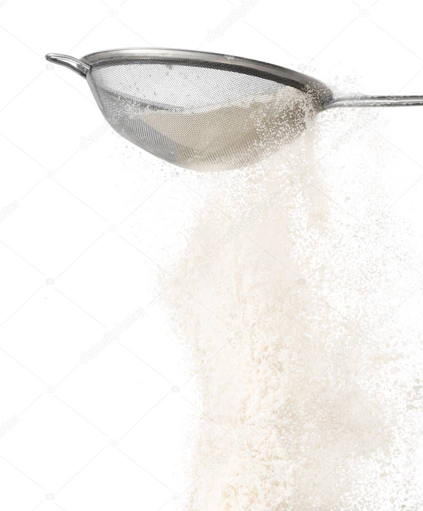 Straining powdered sugar on white background