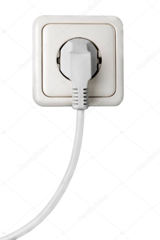 white electrical plug in the electric socket 