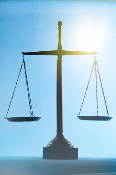 Law scales on table on background
