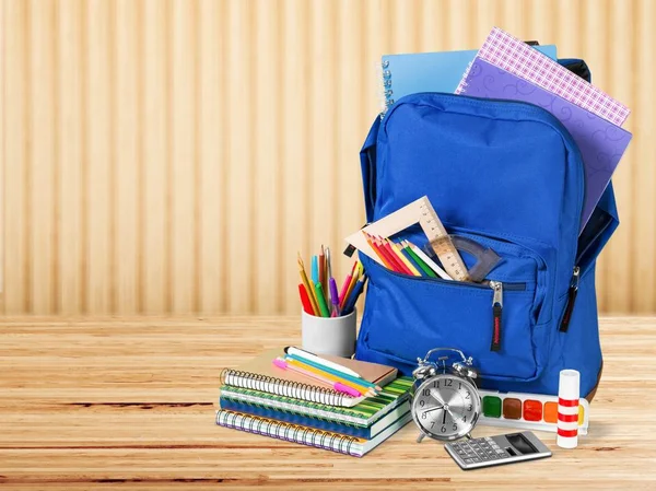 blue backpack and school supplies, back to school