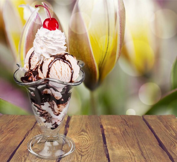 Chocolate ice cream in glass on background