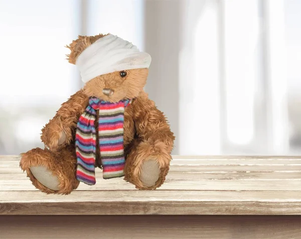 Teddy bear with bandage on head, toy accident