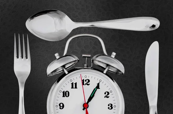 Retro alarm clock with fork, spoon and knife