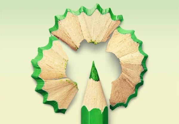 green pencil and pencil shavings on  background