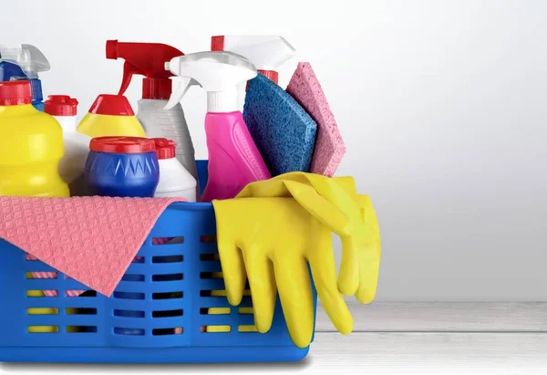 Cleaning supplies in basket isolated on background