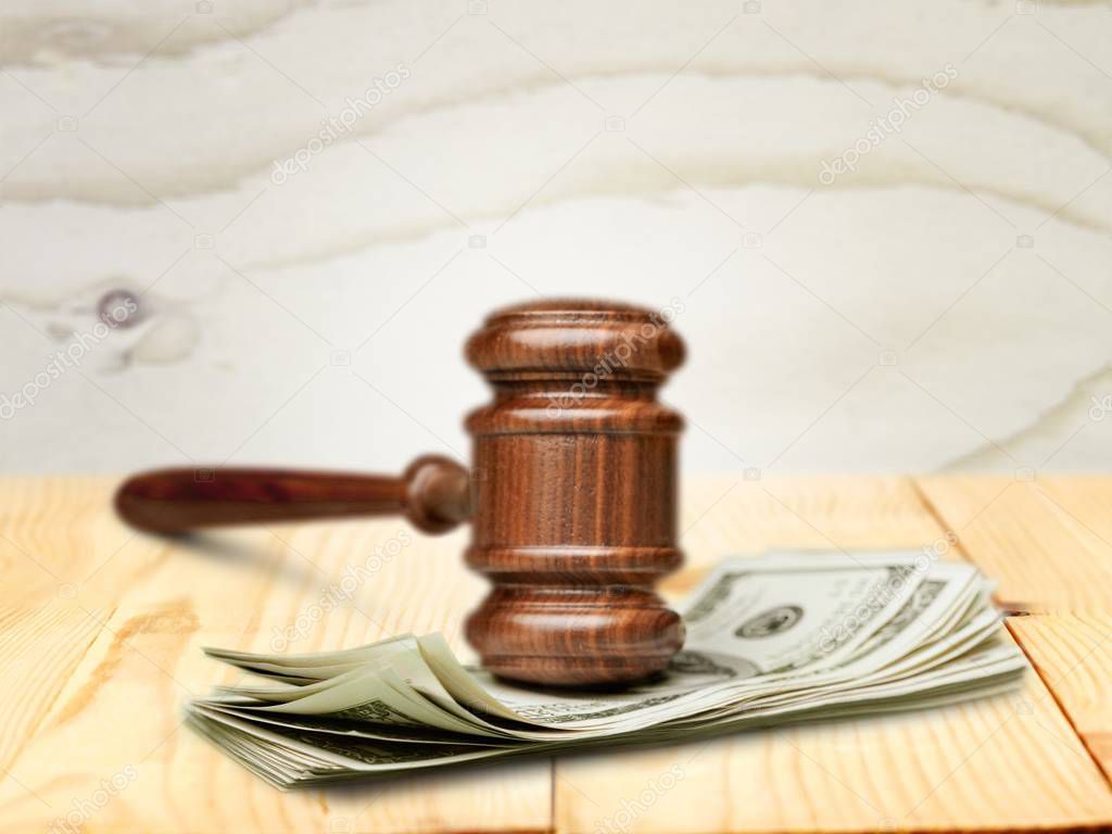Wooden gavel with money, close-up view