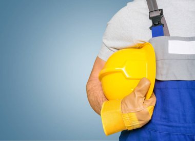 Arka planda miğferi olan işçi.