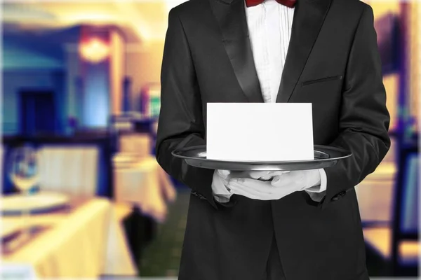 Waiter holding a note card, close-up view