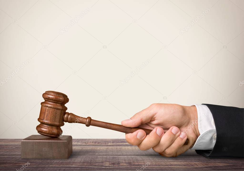 Wooden gavel in hand, justice concept 