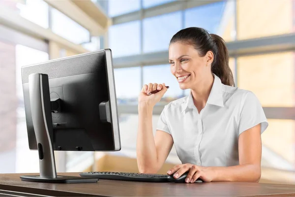 young smiling woman using desktop Computer