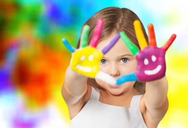 Little girl showing painted hands — Stock Photo, Image