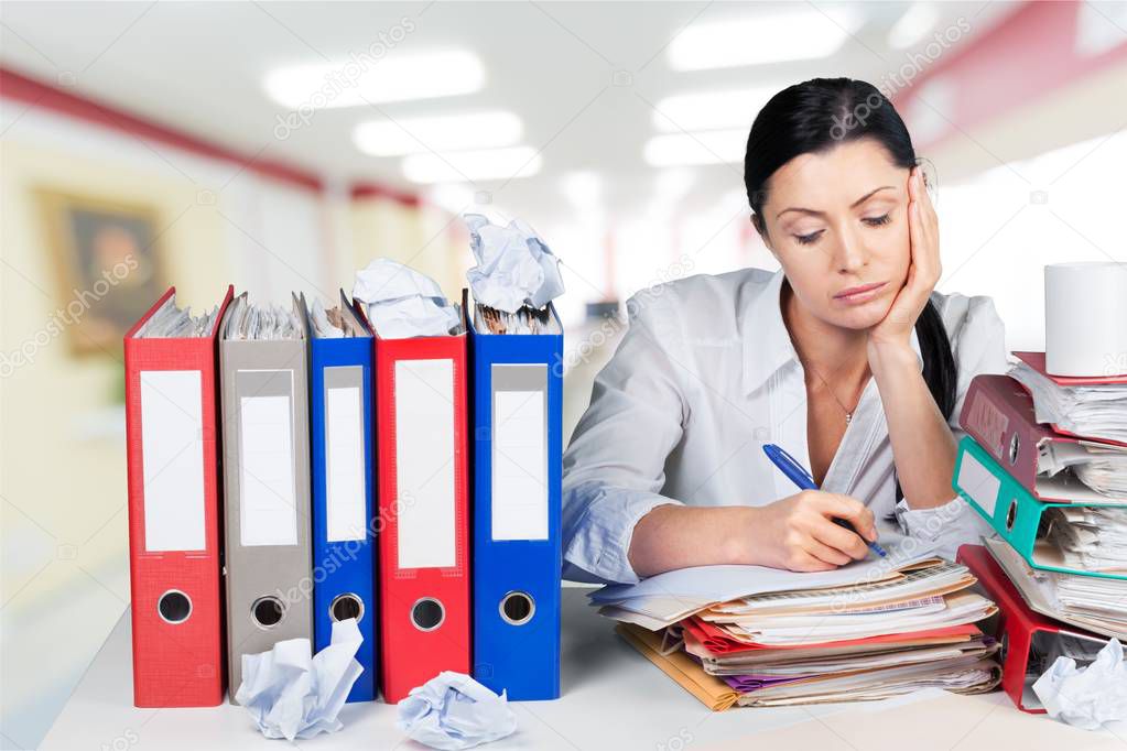 worried  businesswoman with documents on table